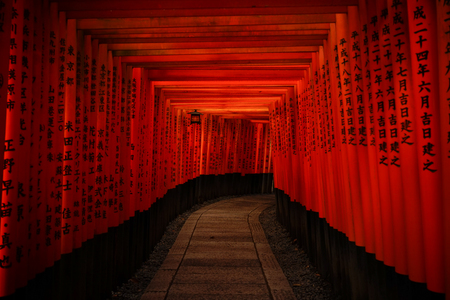 Kyoto, Japan - Apr 6, 2014. The path lined with thousands of Torii (wooden gate) at Fushimi Inari Taisha in Kyoto, Japan.のeditorial素材