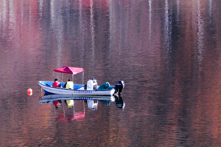 Kawaguchi, Japan - Dec 3, 2013. Fishing boat on autumn lake in Kawaguchi, Japan. The beautiful lake is near Mt. Fuji.のeditorial素材