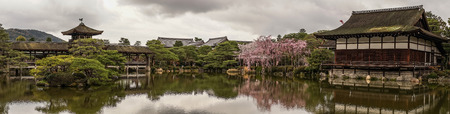 Kyoto, Japan - Apr 6, 2014. Ancient wooden palace with cherry blossom at Heian Jingu Shrine in Kyoto, Japan.のeditorial素材
