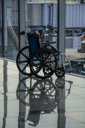 Hanoi, Vietnam - Aug 21, 2016. Folded wheelchair waiting to be used in Noi Bai Airport (HAN).のeditorial素材