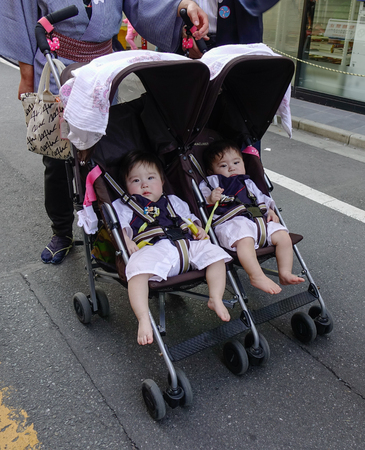 Tokyo, Japan - May 20, 2017. Twin baby in the stroller on street. Since Japan overall population is shrinking due to low fertility rates, the aging population is rapidly increasing.のeditorial素材