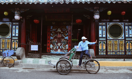 Hoi An, Vietnam - Jan 20, 2019. Cyclo (traditional rickshaw) running on the main street of old town in Hoi An, Vietnam.のeditorial素材