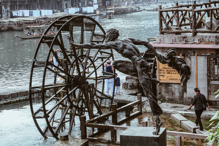Hunan, China - Nov 6, 2015. Bronze statue at Fenghuang Old Town in Hunan, China. The ancient town was added to the UNESCO World Heritage in 2008.のeditorial素材
