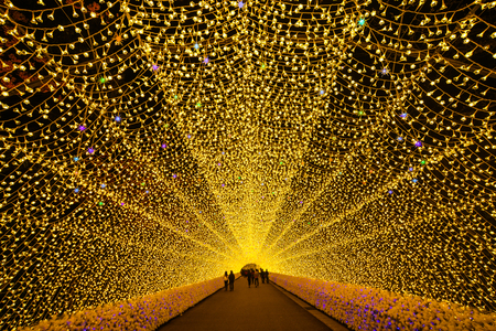 Nagoya, Japan - Mar 16, 2018. Giant led light tunnel in Nabana No Sato Park. Many tourists sightseeing walking and taking a picture in the tunnel.のeditorial素材