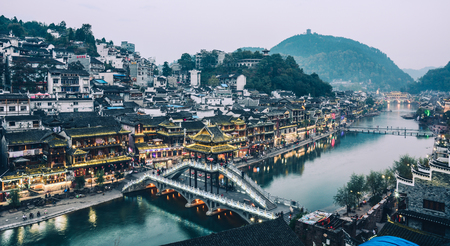 Hunan, China - Nov 6, 2015. Night view of Fenghuang Old Town in Hunan, China. The ancient town was...