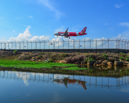 Phuket, Thailand - Apr 5, 2019. AirAsia Airbus A320 landing above the sand beach near Phuket Airport (HKT).のeditorial素材