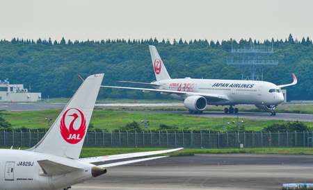 Tokyo, Japan - Jul 3, 2019. JA01XJ Japan Airlines Airbus A350-900 (A350 Red Livery) taxiing on runway of Tokyo Narita Airport (NRT).のeditorial素材