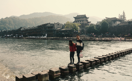 Hunan, China - Nov 6, 2015. People visit Fenghuang Old Town in Hunan, China. The ancient town was added to the UNESCO World Heritage in 2008.のeditorial素材