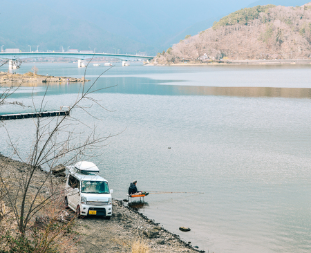 Yamanashi, Japan - Apr 8, 2019. Fisherman with a car enjoying at beautiful lake in Yamanashi, Japan.のeditorial素材
