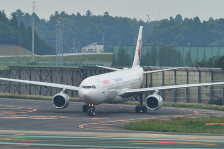 Tokyo, Japan - Jul 3, 2019. China Eastern Airlines B-8971 (Airbus A330-300) taxiing on runway of Tokyo Narita Airport (NRT). Narita is one of the busiest airports in Asia.のeditorial素材