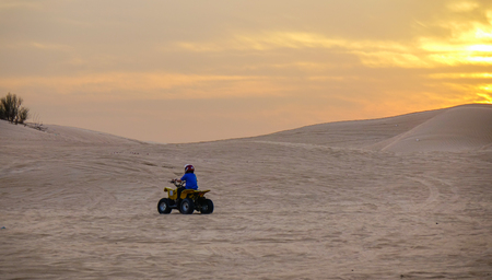 Dubai, UAE - Dec 5, 2018. Riding quadbike on the Dubai desert. Riding Quad Bike is a memorable experience when visiting Dubai.のeditorial素材
