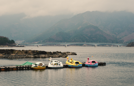 Kawaguchiko, Japan - Apr 8, 2019. Pedal swan boats on the Kawaguchiko Lake, Japan. Kawaguchiko is a mountain lake near famous Mount Fuji.のeditorial素材