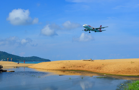 Phuket, Thailand - Apr 5, 2019. HS-ABG Thai AirAsia Airbus A320 (Thailand Post Livery) landing above...