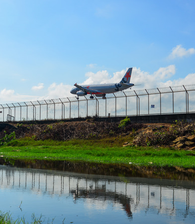 Phuket, Thailand - Apr 5, 2019. A Jetstar Airbus A320 landing above the sand beach near Phuket Airport (HKT).のeditorial素材