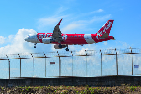 Phuket, Thailand - Apr 5, 2019. AirAsia Airbus A320 landing above the sand beach near Phuket Airport...