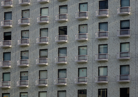 Tokyo, Japan - Apr 9, 2019. Facade of modern apartment at downtown in Tokyo, Japan. Tokyo has the largest metropolitan economy in the world.のeditorial素材