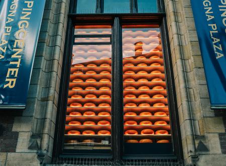 Amsterdam, Holland - Oct 7, 2018. Display of forms of Dutch cheese in a shop in Amsterdam.のeditorial素材