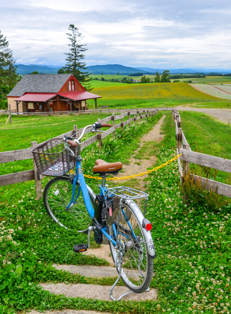 Furano, Japan - Jul 1, 2019. Bicycle on the rural road in Furano, Hokkaido, Japan. Furano is a highland town that attracts visitors in the summer.のeditorial素材