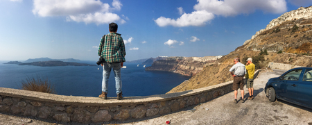 Santorini, Greece - Oct 4, 2018. Asian young man enjoying at sunny day on Santorini Island, Greece.のeditorial素材