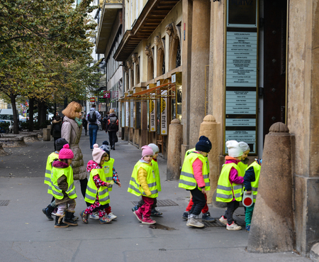 Prague, Czech - Oct 26, 2018. Small pupils in reflective vest cross the road at old town in Prague, Czechia.のeditorial素材