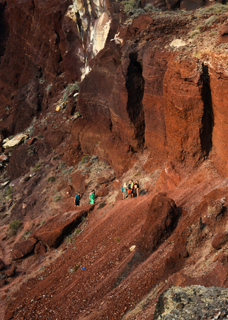 Santorini, Greece - Oct 10, 2018. Trekking on the red volcano mountain near red beach on Santorini Island, Greece.のeditorial素材