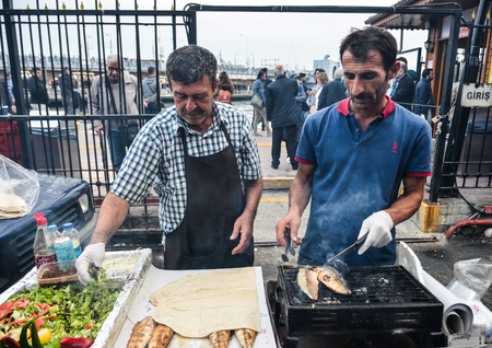 Istanbul, Turkey - Sep 29, 2018. Local men selling grilled fish with bread in Istanbul, Turkey. Istanbul is one of the most destinations in Turkey.のeditorial素材