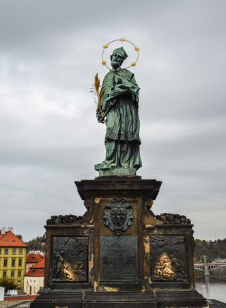 Ancient bronze statue located on the side of Charles Bridge in Prague, Czechia.のeditorial素材