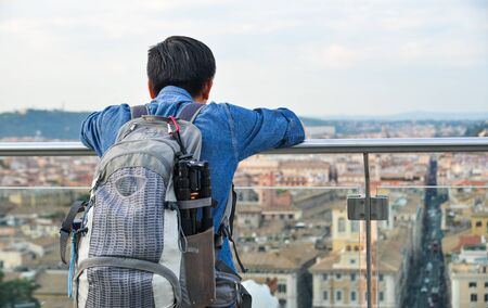 A man looking at the ancient cityscape on observation deck of Monument to Vittorio Emanuele II in...