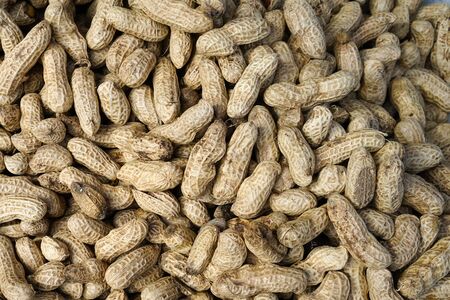 Pile of peanut in shell texture at market for food and agriculture concept design.