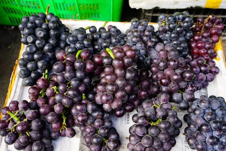 Sichuan, China - Aug 16, 2016. Ripe grapes on the farmer market in Chengdu, Sichuan Province, China.のeditorial素材