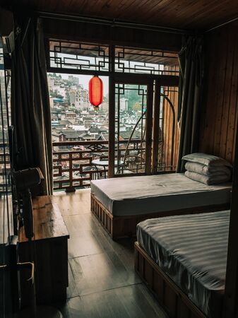 Hunan, China - Nov 6, 2015. Chinese traditional style bedroom interior of typical hotel in Fenghuang Ancient Town, Hunan, China.のeditorial素材