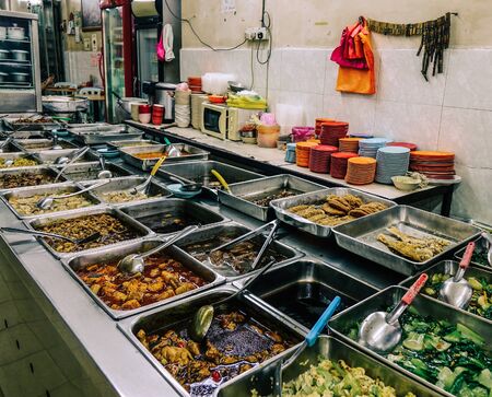 Food trays at cheap restaurant in Kuala Lumpur, Malaysia. Kuala Lumpur is the cultural, financial and economic centre of Malaysia.の写真素材