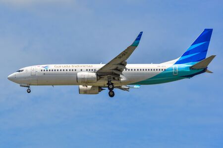 Singapore - Mar 27, 2019. PK-GFV Garuda Indonesia Boeing 737-800 landing at Changi Airport (SIN). Changi serves more than 100 airlines flying to 400 cities.のeditorial素材