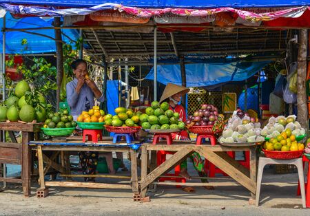 Soc Trang, Vietnam - Jan 19, 2020. A vendor selling fresh fruits at a rural market in Mekong Delta, Vietnam.のeditorial素材