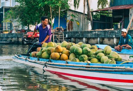 Soc Trang, Vietnam - Jan 19, 2020. People using wooden boat on Mekong River. Wooden boats are the main means of transportation in Mekong Delta, Vietnam.のeditorial素材