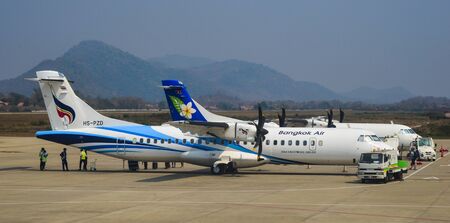 Vientiane, Laos - Feb 8, 2020. Passenger airplanes taxiing on runway of Vientiane Wattay...