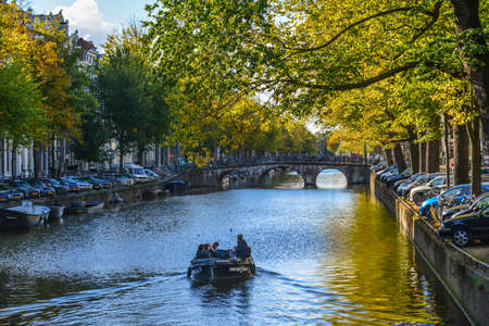 Amsterdam, Holland - Oct 7, 2018. Cityscape with canal of Amsterdam, Holland. Amsterdam known for its artistic heritage and narrow houses with gabled facades.のeditorial素材