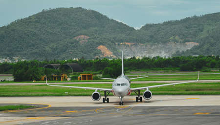 Passenger airplane on runway of Da Nang Airport (DAD), Vietnam.のeditorial素材