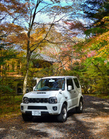Karuizawa, Japan - Nov 7, 2019. Car on rural road in Karuizawa, Japan. Karuizawa is a resort in the mountains of Nagano, famous for its autumn nature.のeditorial素材