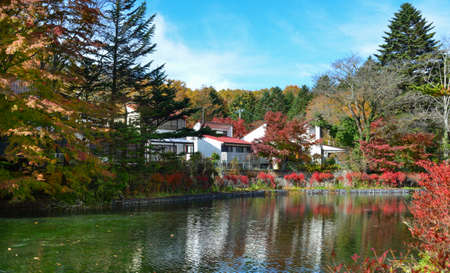 Beautiful lake view in autumn in Karuizawa, Japan, with many maple trees turning bright red.のeditorial素材