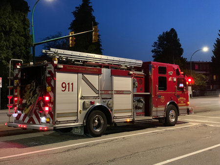 Fire truck on the road in the city at night with red lights