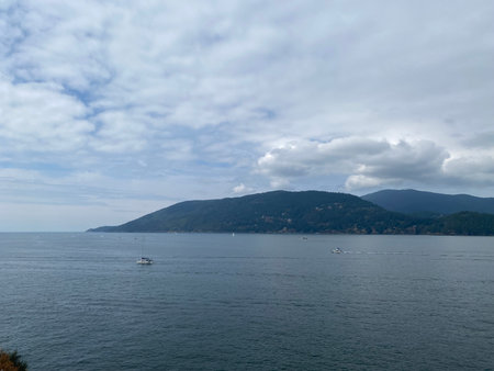 View of the sea, mountains and clouds on a sunny day.