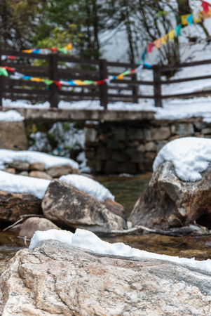 Snow-capped mountains and streams and rockの写真素材