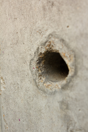 black hole in in white wall as a backgroundの写真素材