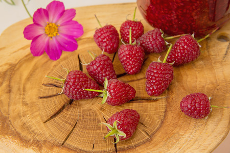 Red fresh raspberries on brown rustic wood background  with beautiful structure.. Natural ripe...