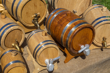 Small wine casks are made with old technology and sold at the fair. 7 oak barrels with hoops.