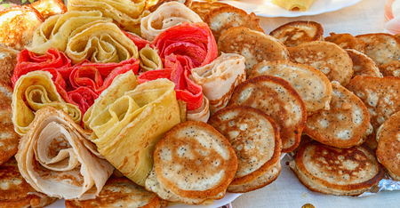 muffins and pancakes are on the white tablecloth outdoors. traditional pancakes on Shrove Tuesday.の写真素材