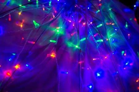 Beautiful scattered light through a transparent umbrella. Bright saturated festive background of...