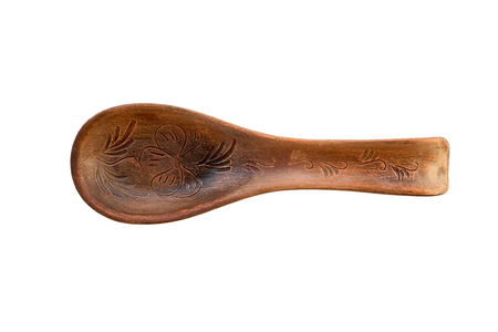 Object one large red ceramic spoon is presented on a white background. Large clay spoon with rest ornament isolated on white. Ceramic holder with spoon on white background. The view from the top.の写真素材