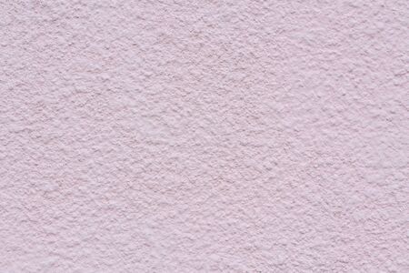 Texture of a painted light pink concrete wall. Abstract architectural background. external plaster.の写真素材